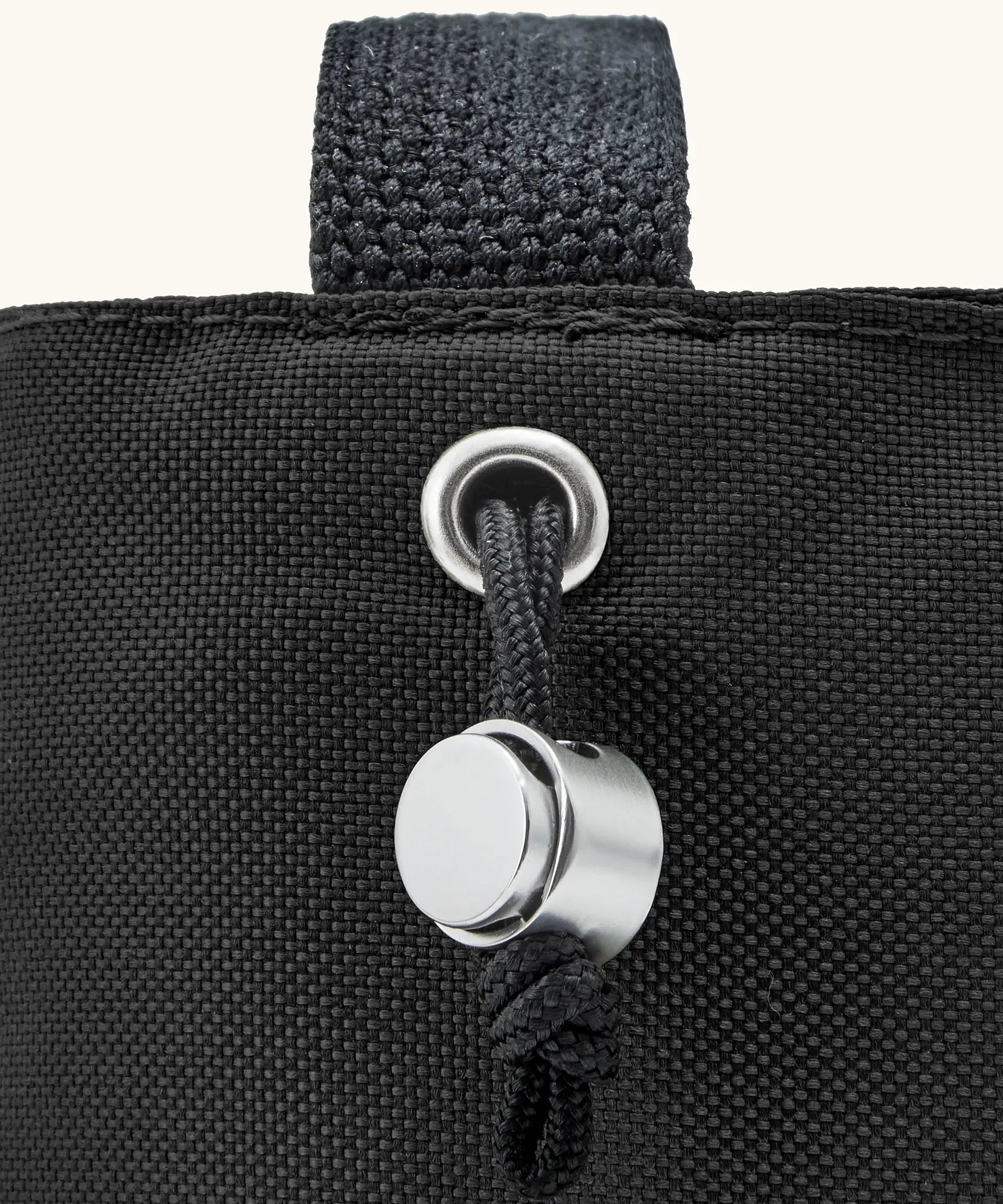 Black + Blum insulated bottle bag in black showing a close up of the adjustable drawstring for holding bottles