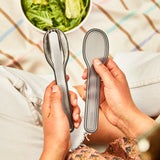 A close up of the Black+Blum Cutlery Set With Portable Hygienic Carry Case shown in a person's hands.