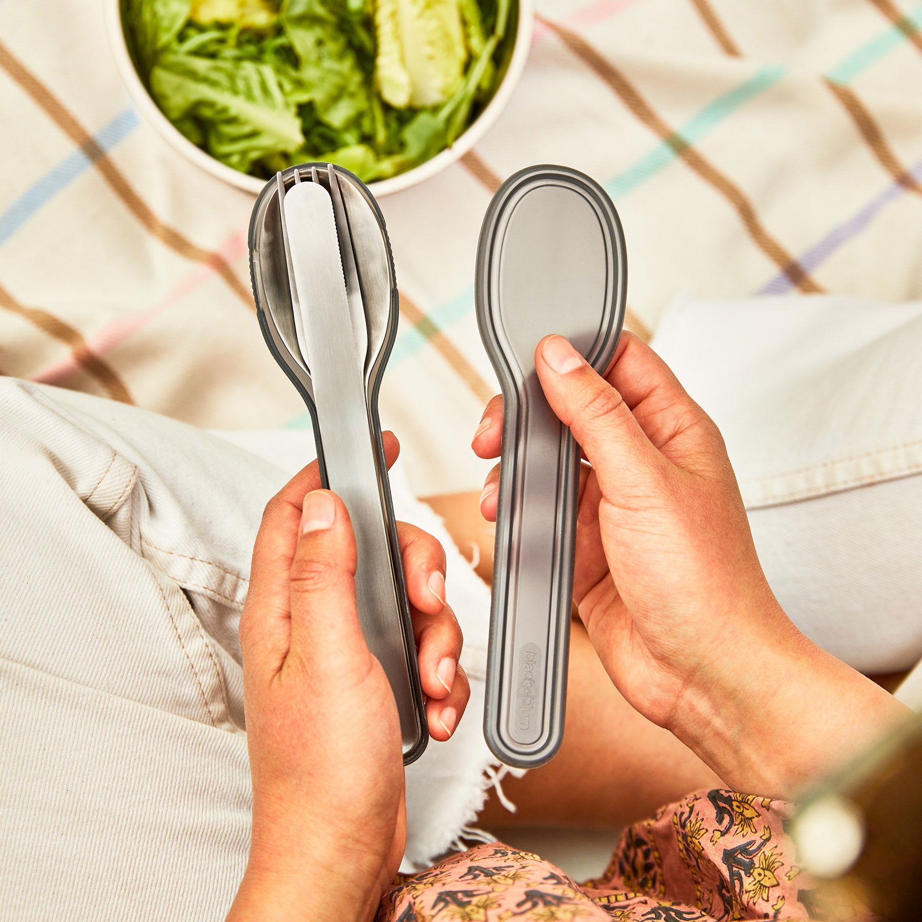 A close up of the Black+Blum Cutlery Set With Portable Hygienic Carry Case shown in a person's hands.
