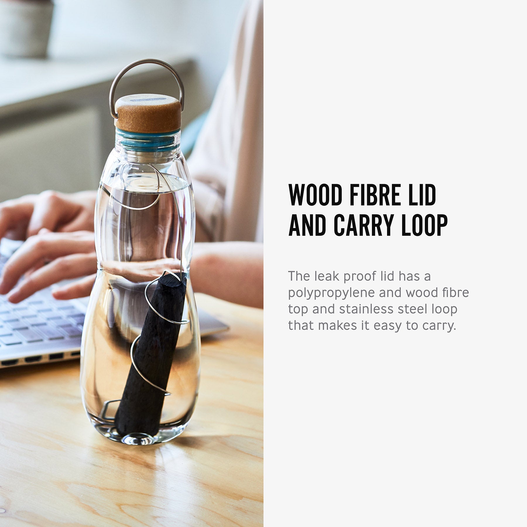 The charcoal filter and spring shown inside the glass bottle from black and blum long side text. The text reads, wood fibre lid and carry loop. the leak proof lid has a polypropylene and wood fibre top and stainless steel loop that makes it easy to carry.  