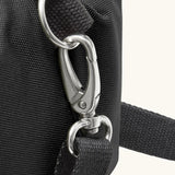 Black+Blum 10 litres insulated roll top lunch bag in black showing a close of carry strap hooked on the side loop