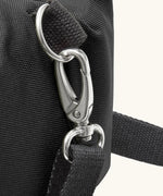 Black+Blum 10 litres insulated roll top lunch bag in black showing a close of carry strap hooked on the side loop