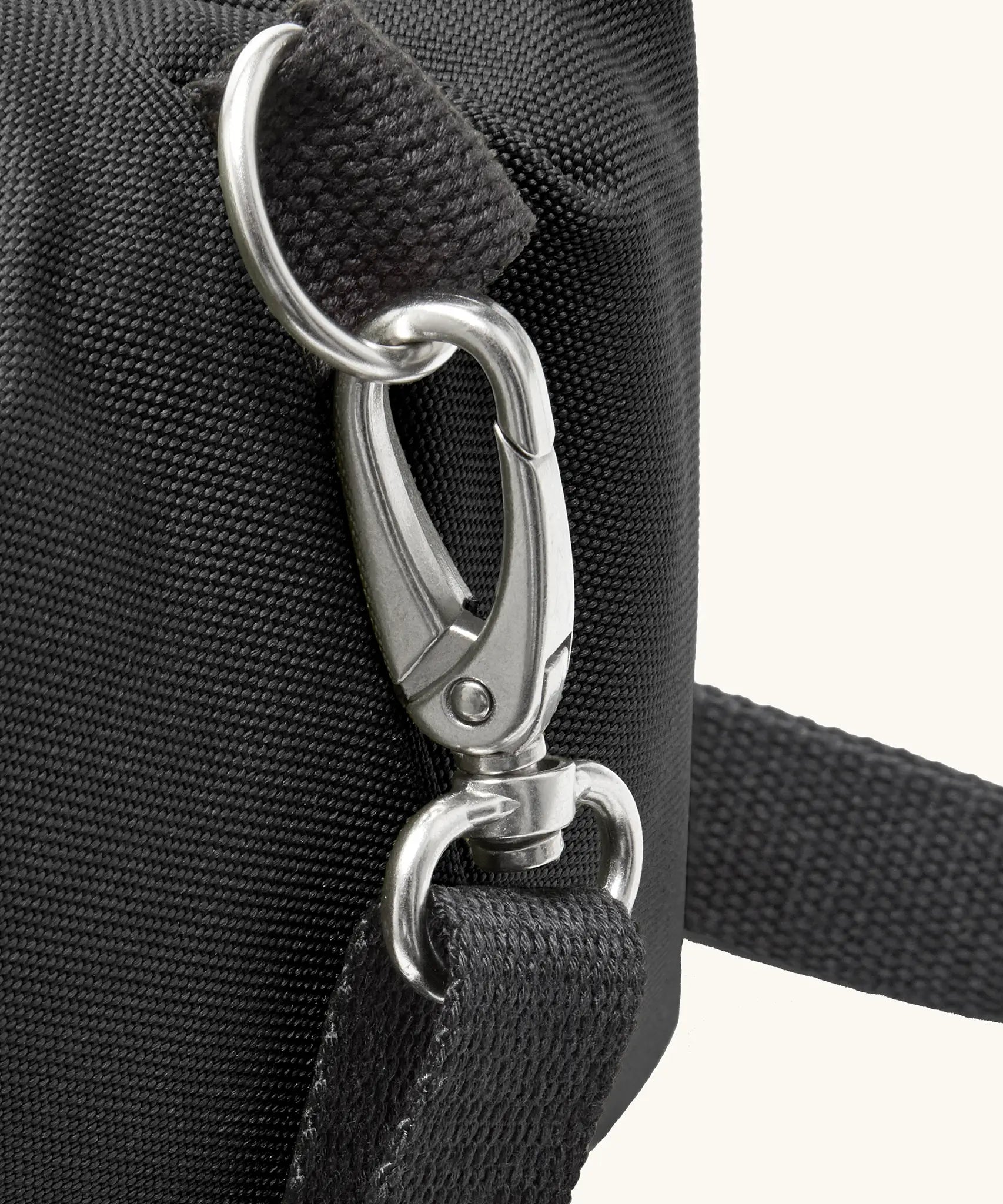 Black+Blum 10 litres insulated roll top lunch bag in black showing a close of carry strap hooked on the side loop
