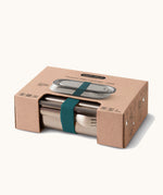 Black+Blum Large Leak Proof Stainless Steel Lunch Box with ocean coloured strap shown in it's cardboard packaging box. This lunchbox is part of a wide range of stainless steel lunch box options available here at Babipur. 