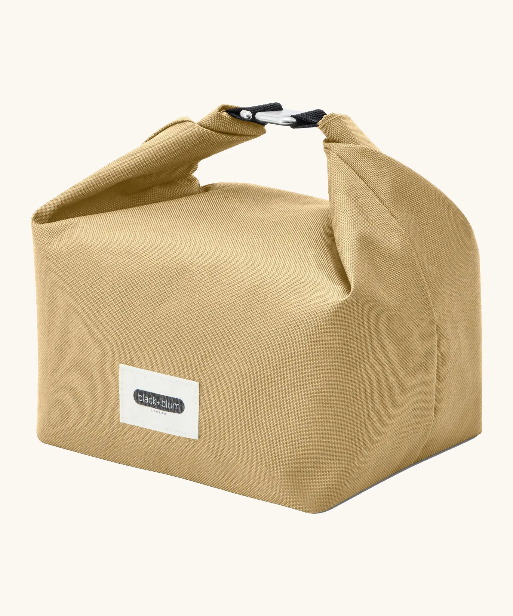 Black+Blum 7 litres insulated and water repellent roll top lunch bag in clay beige standing on an angle