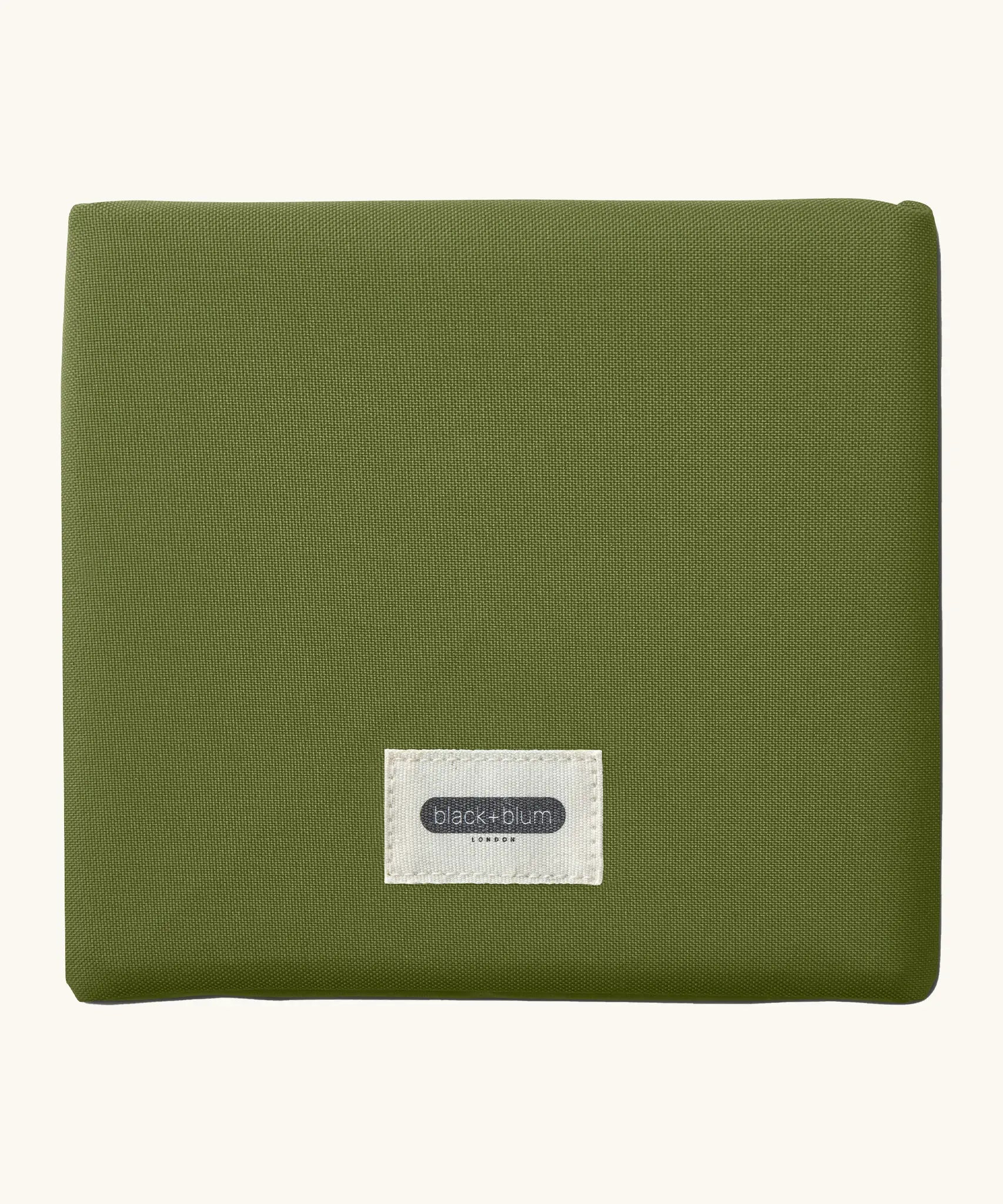 A moss green Black+Blum 7 litres insulated and water repellent roll top lunch bag folded neatly into a square