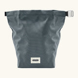 An open A slate blue Black+Blum water repellent roll top lunch bag with contents inside 