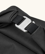 Close up the metal hook buckle fastener for the Black+Blum roll top lunch bag in black 