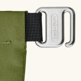 Close up of the metal hook buckle fastener on the moss green Black+Blum water repellent roll top lunch bag