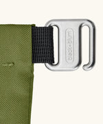 Close up of the metal hook buckle fastener on the moss green Black+Blum water repellent roll top lunch bag