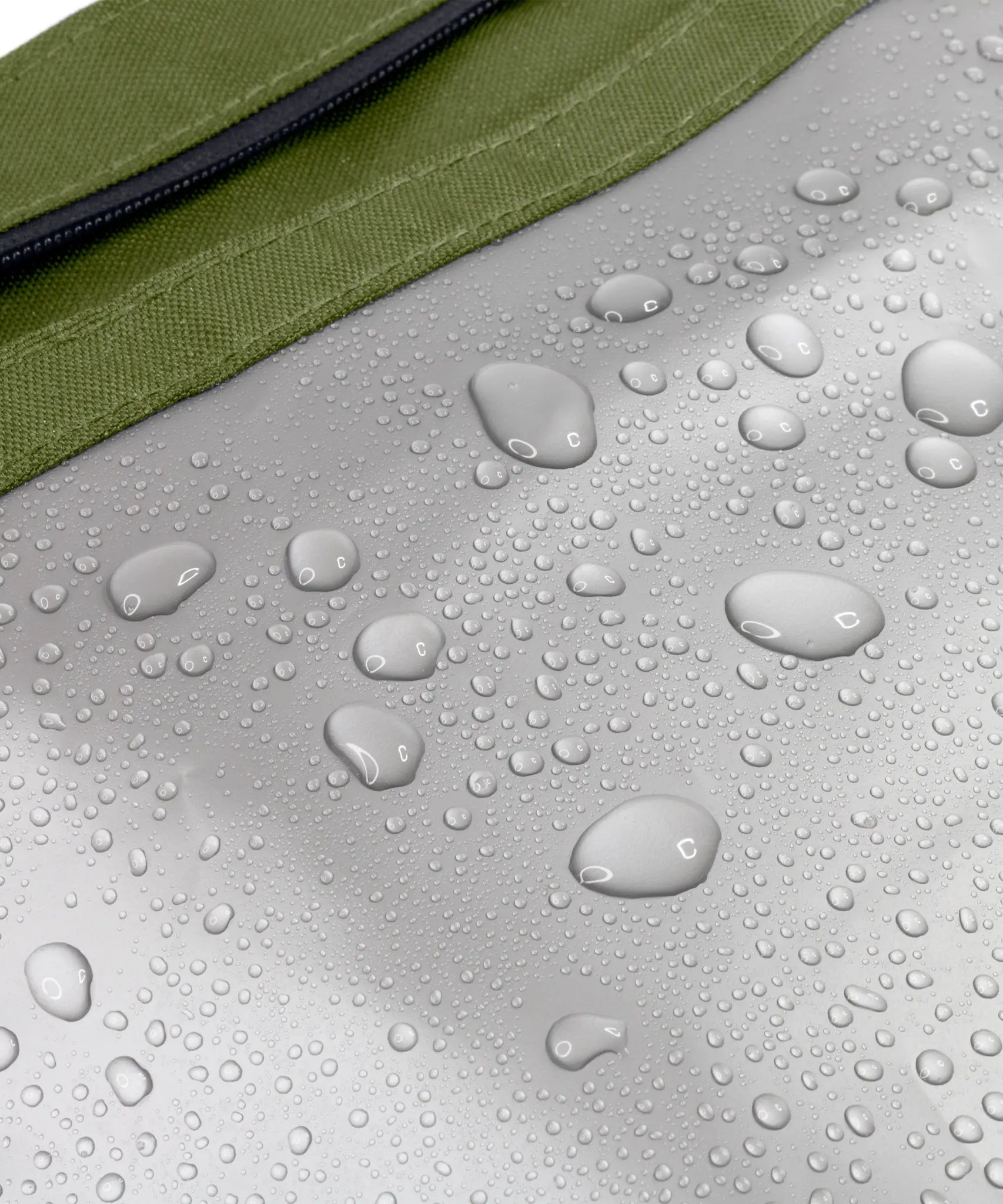 The water repellent lining on the moss green Black+Blum lunch bag showing trickling water