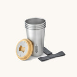 A close up of the set of 4 Black + Blum stainless steel cups showing the bamboo lid bottle opener detail