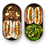 Two open Black+Blum 500ml stainless steel leakproof lunchboxes showing fresh food inside both