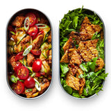 Two open Black+Blum 500ml stainless steel leakproof lunchboxes showing fresh salad inside both