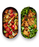 Two open Black+Blum 500ml stainless steel leakproof lunchboxes showing fresh salad inside both