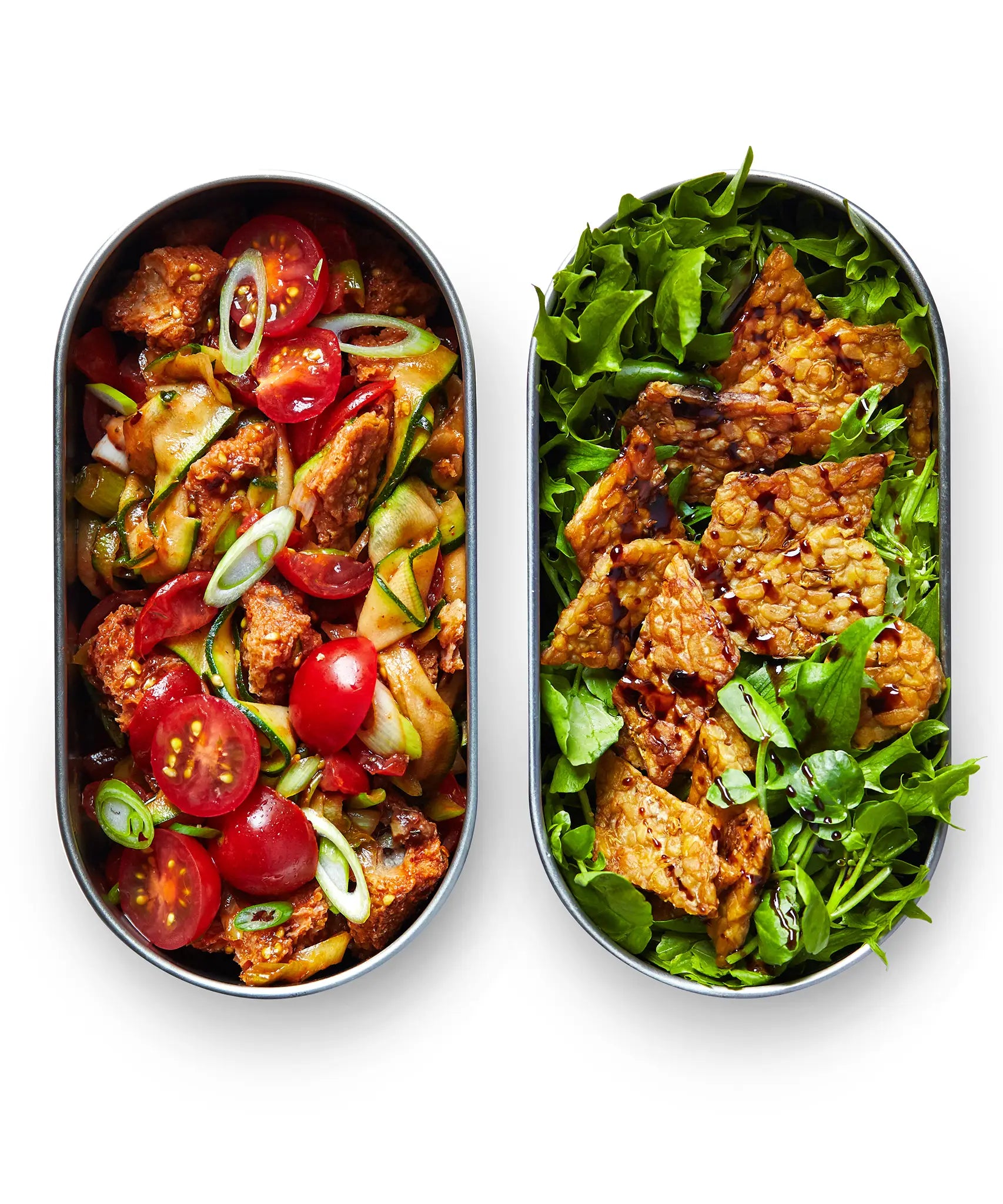 Two open Black+Blum 500ml stainless steel leakproof lunchboxes showing fresh salad inside both