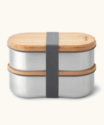 Two Black+Blum 500ml stainless steel leakproof boxes with a bamboo lid/chopping board and nylon strap