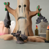 All 3 Bumbu bat figures in a spooky playscene including a spooky tree, candles ghosts and a tombstone all available at Babipur.