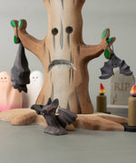 All 3 Bumbu bat figures in a spooky playscene including a spooky tree, candles ghosts and a tombstone all available at Babipur.