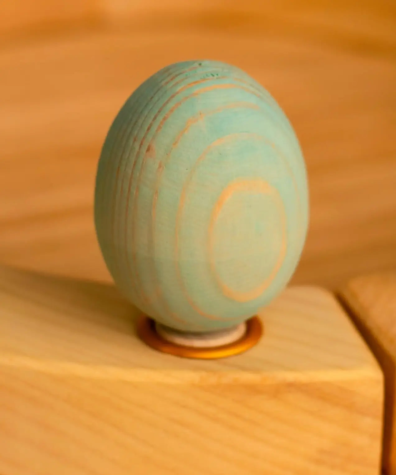 Bumbu wooden blue egg decorative figure standing in a celebration ring