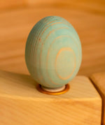 Bumbu wooden blue egg decorative figure standing in a celebration ring