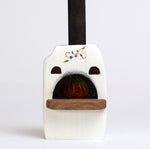Close up of the Bumbu wooden pizza oven toy on a white background
