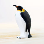 Bumbu eco-friendly childrens wooden emperor penguin figure stood on a light wooden work top in front of a white background