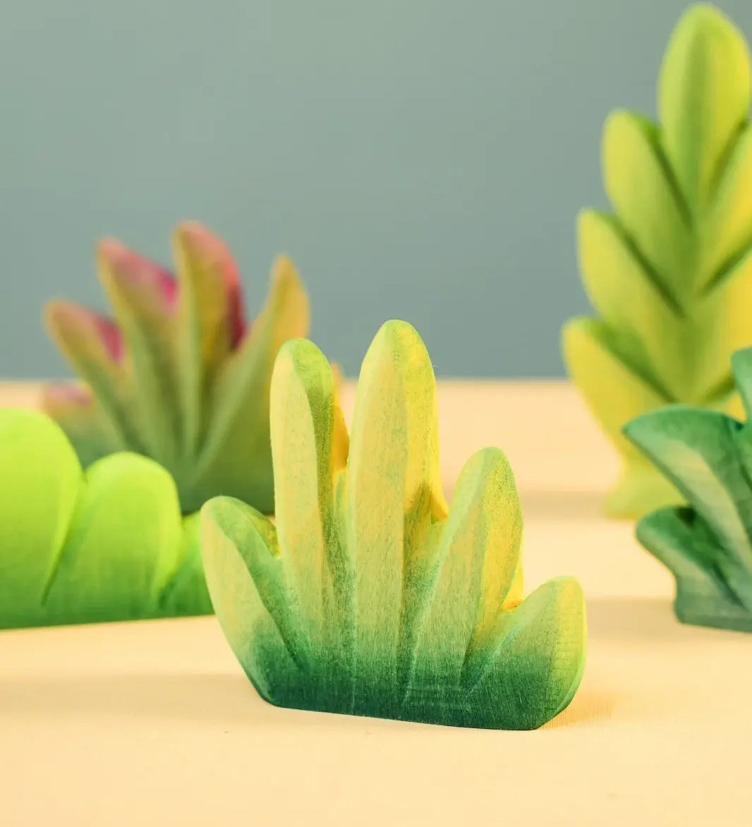 Bumbu Toys dessert bush for small world play with other bushes in the background.