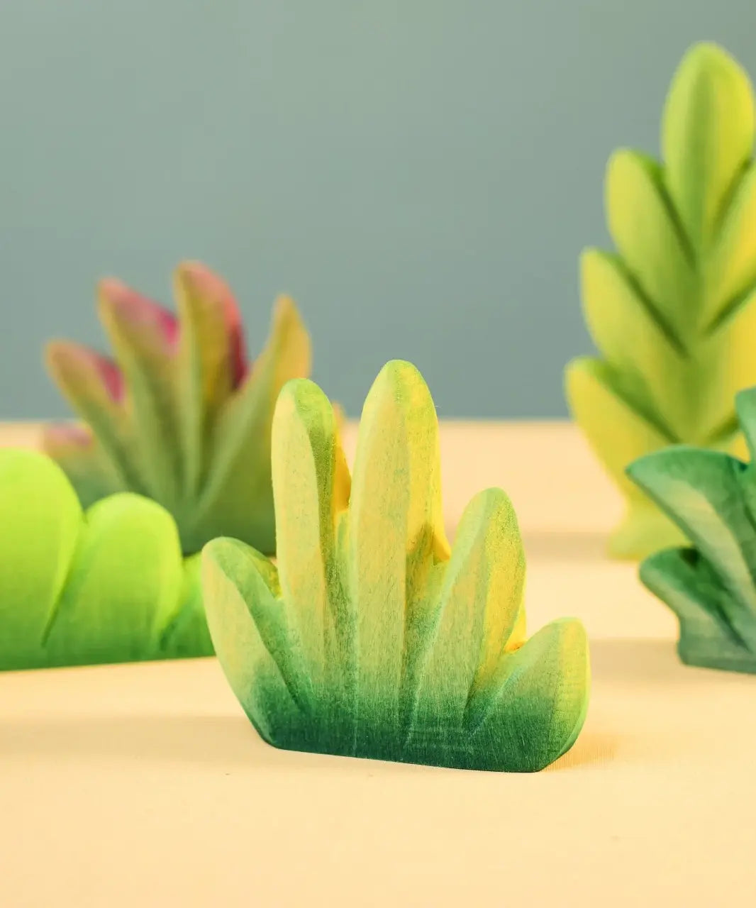 Bumbu Toys dessert bush for small world play with other bushes in the background.