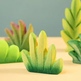 Bumbu Toys dessert bush for small world play with other bushes in the background.