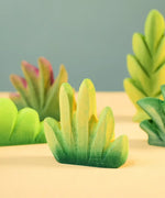 Bumbu Toys dessert bush for small world play with other bushes in the background.