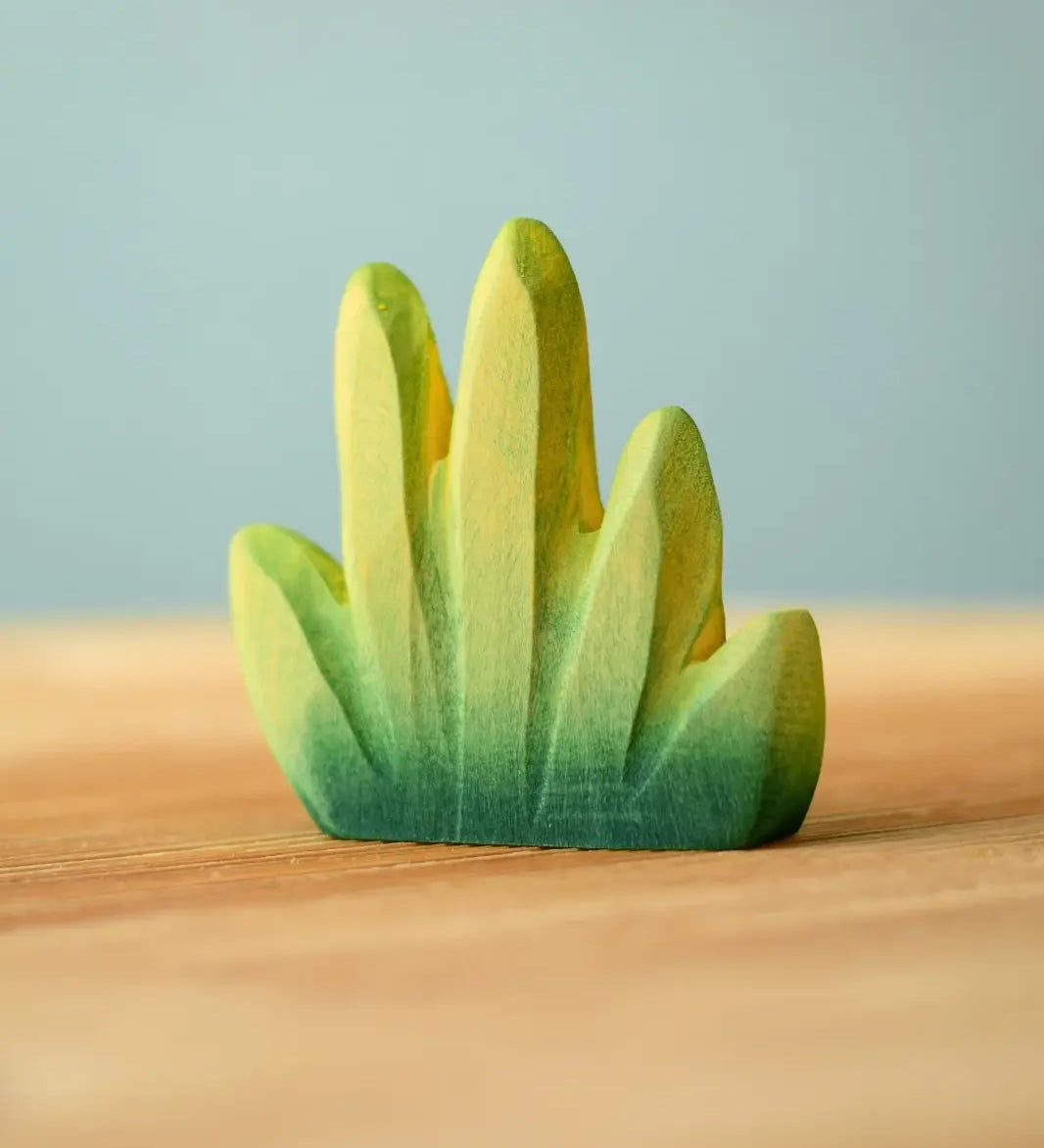 Bumbu Toys dessert bush for small world play placed on a wooden surface.