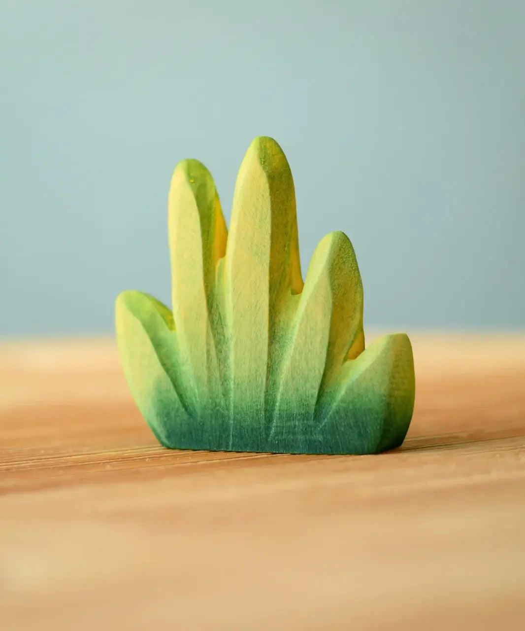 Bumbu Toys dessert bush for small world play placed on a wooden surface.