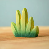 Bumbu Toys dessert bush for small world play placed on a wooden surface.