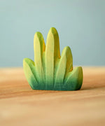 Bumbu Toys dessert bush for small world play placed on a wooden surface.