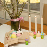 Easter display showing blue, pink and yellow Bumbu eggs with white rabbits and spring flower figures