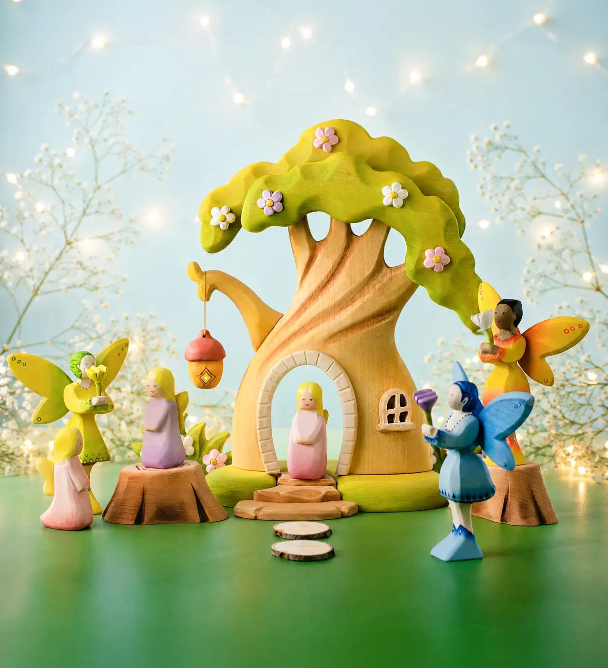 A fairytale inspired playscene showing the Bumbu wooden fairy treehouse and fairy figures 