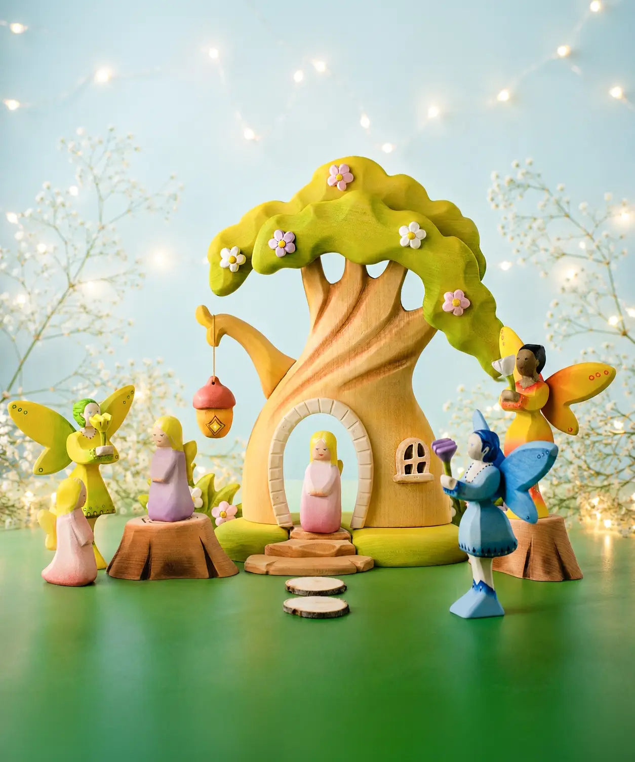 A fairytale inspired playscene showing the Bumbu wooden fairy treehouse and fairy figures 