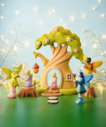 A fairytale inspired playscene showing the Bumbu wooden fairy treehouse and fairy figures 