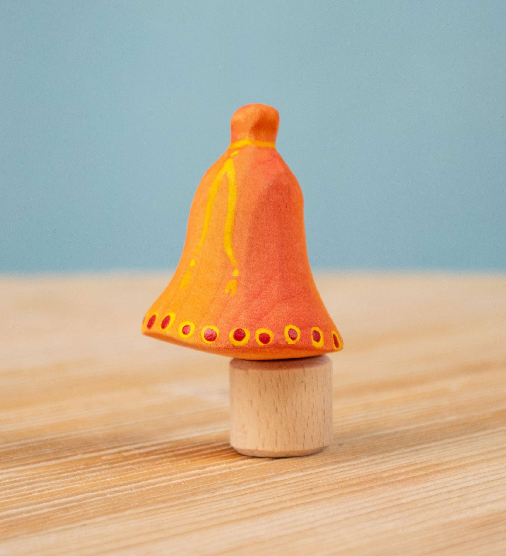 Bumbu Festive Bell Celebration decorative Figure to fit on a Grimm's celebration ring. These festive figures are perfect for your Christmas celebration ring set up. These expertly hand crafted items are part of a large range of wooden toys available here at Babipur. 