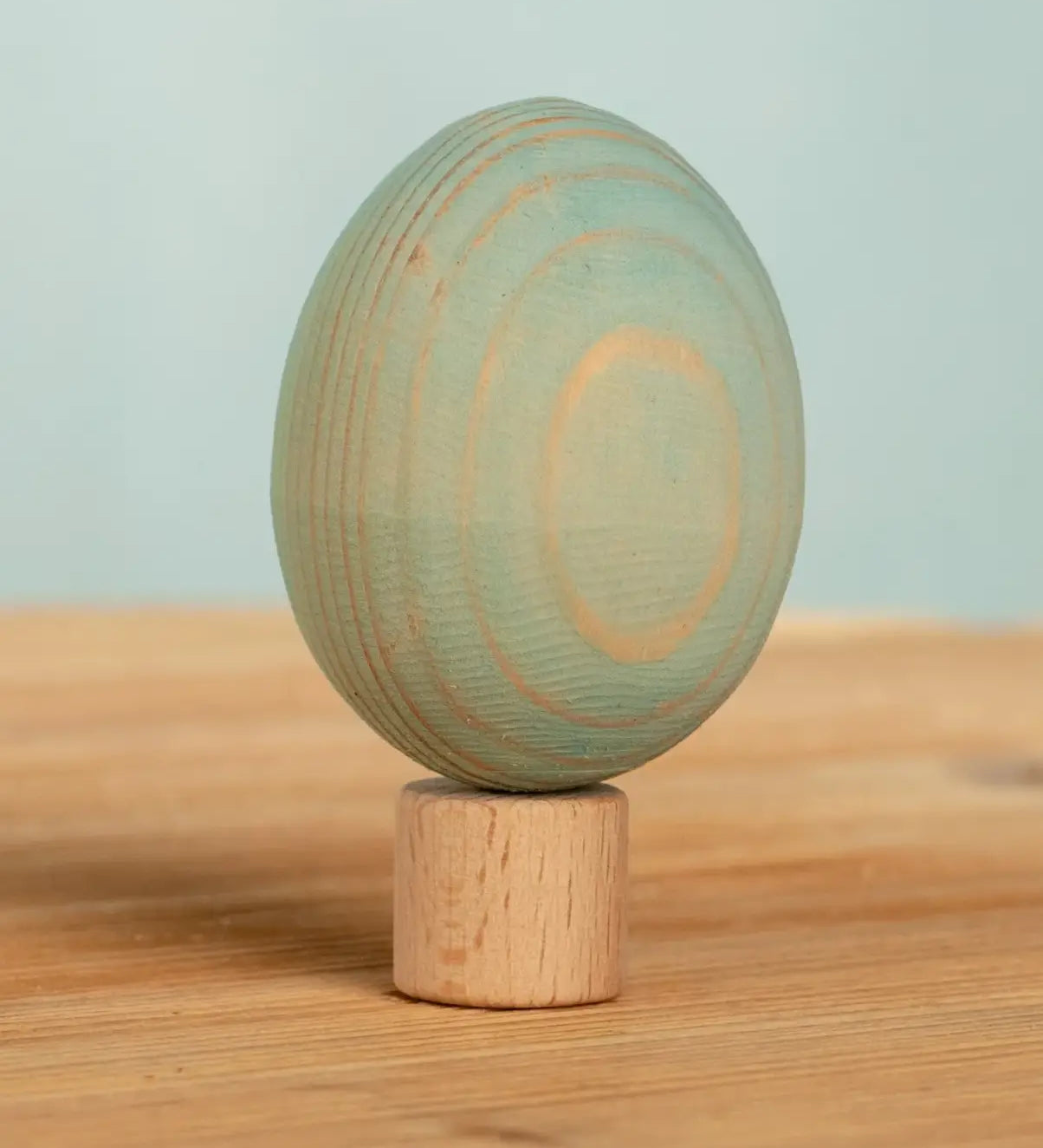 Bumbu handcrafted wooden blue egg figure standing on wooden base for Grimms celebration ring