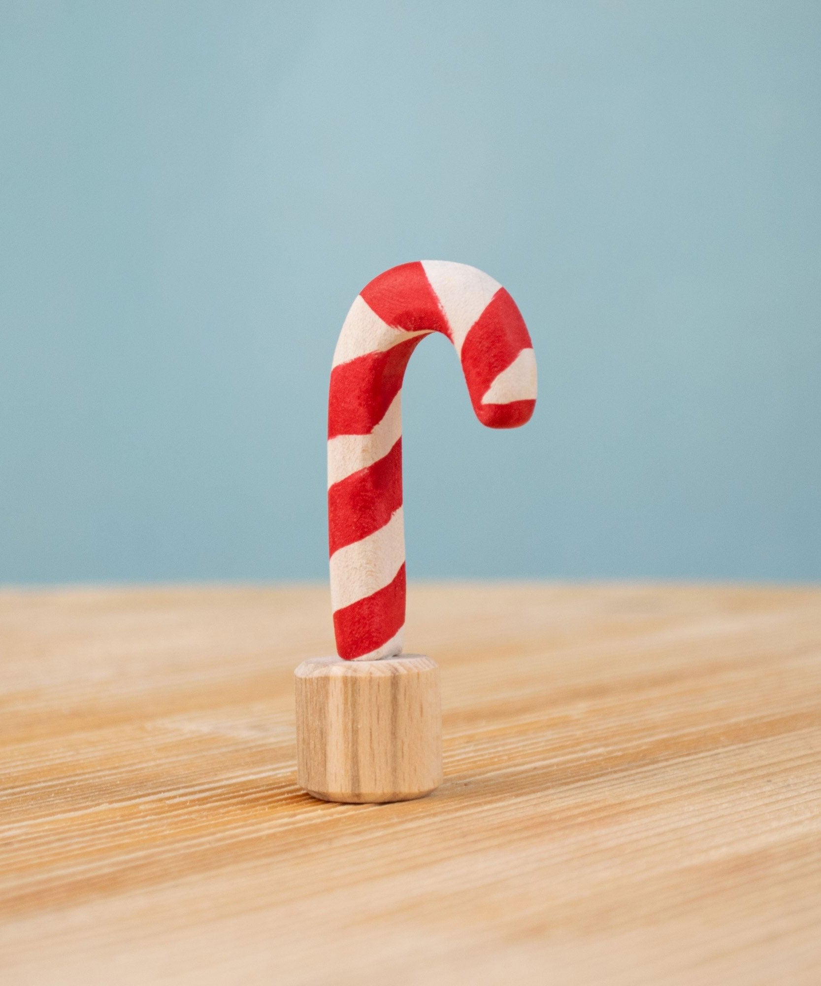 Bumbu red and white Festive Candy Cane Celebration ring decorative Figure to fit on a Grimm's celebration ring. These festive figures are perfect for your Christmas celebration ring set up. These expertly hand crafted items are part of a large range of wooden toys available here at Babipur. 