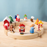 A collection of Bumbu Festive Celebration ring decorative Figures shown on a wooden ring. These festive figures are perfect for your Christmas celebration ring set up. These expertly hand crafted items are part of a large range of wooden toys available here at Babipur. 