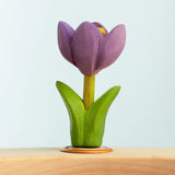 Bumbu wooden hand painted purple festive crocus decorative figure standing in a celebration ring against a blue background