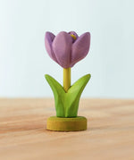 Bumbu handcrafted wooden purple festive crocus figure standing on a wooden green base 