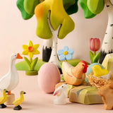 A Easter play setup showing Bumbu spring related figures including a goose, ,chick, rabbit, hen, flowers and trees
