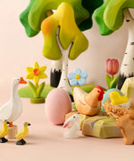 A Easter play setup showing Bumbu spring related figures including a goose, ,chick, rabbit, hen, flowers and trees