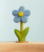 Bumbu wooden hand painted blue festive forget me not decorative figure standing in a celebration ring against a blue background