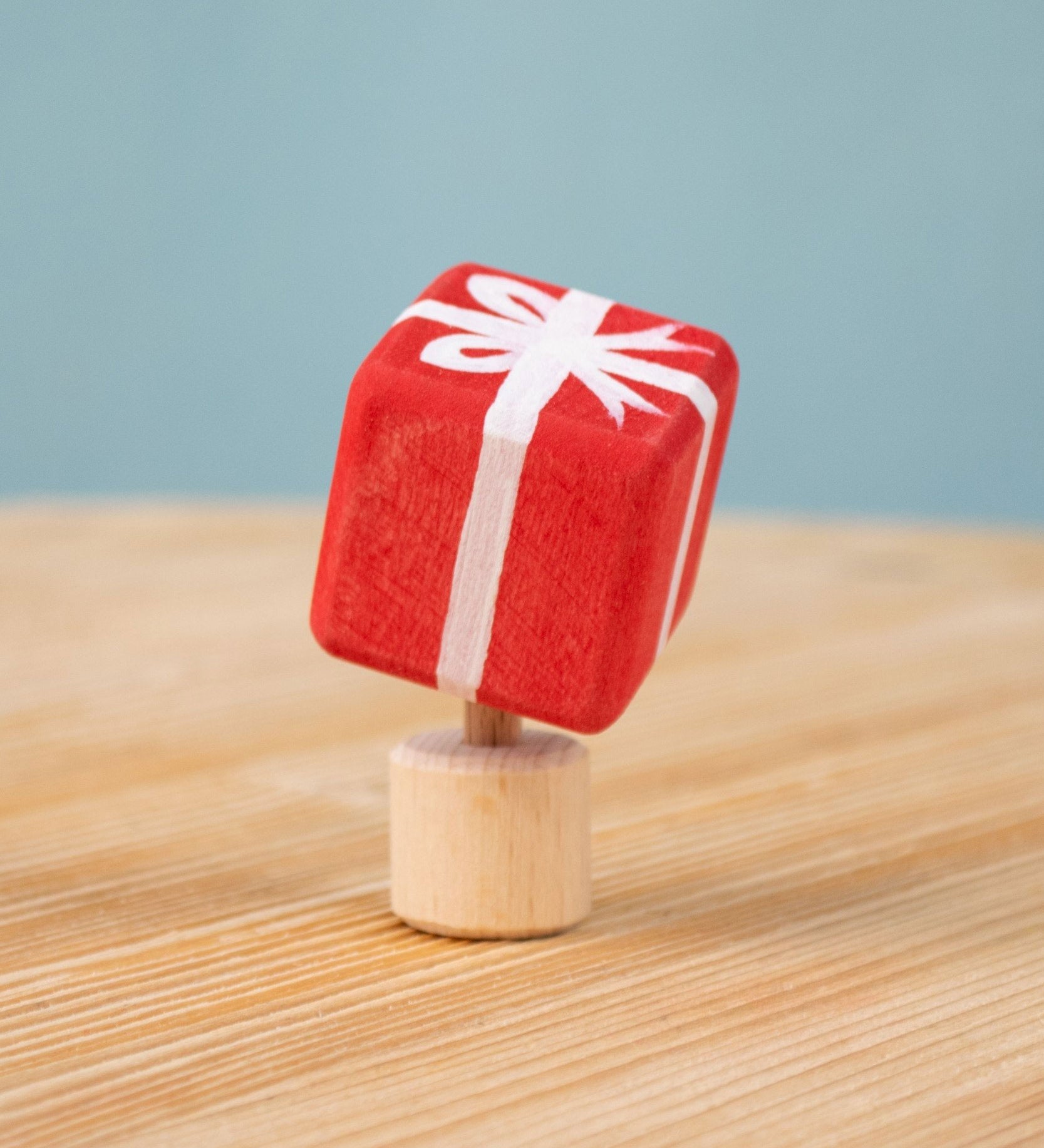 Bumbu red Festive Gift Celebration decorative Figure to fit on a Grimm's celebration ring. These festive figures are perfect for your Chritmas celebration ring set up. Bumbu red Festive Gift Celebration decorative Figure to fit on a Grimm's celebration ring. These festive figures are perfect for your Christmas celebration ring set up. These expertly hand crafted items are part of a large range of wooden toys available here at Babipur. 