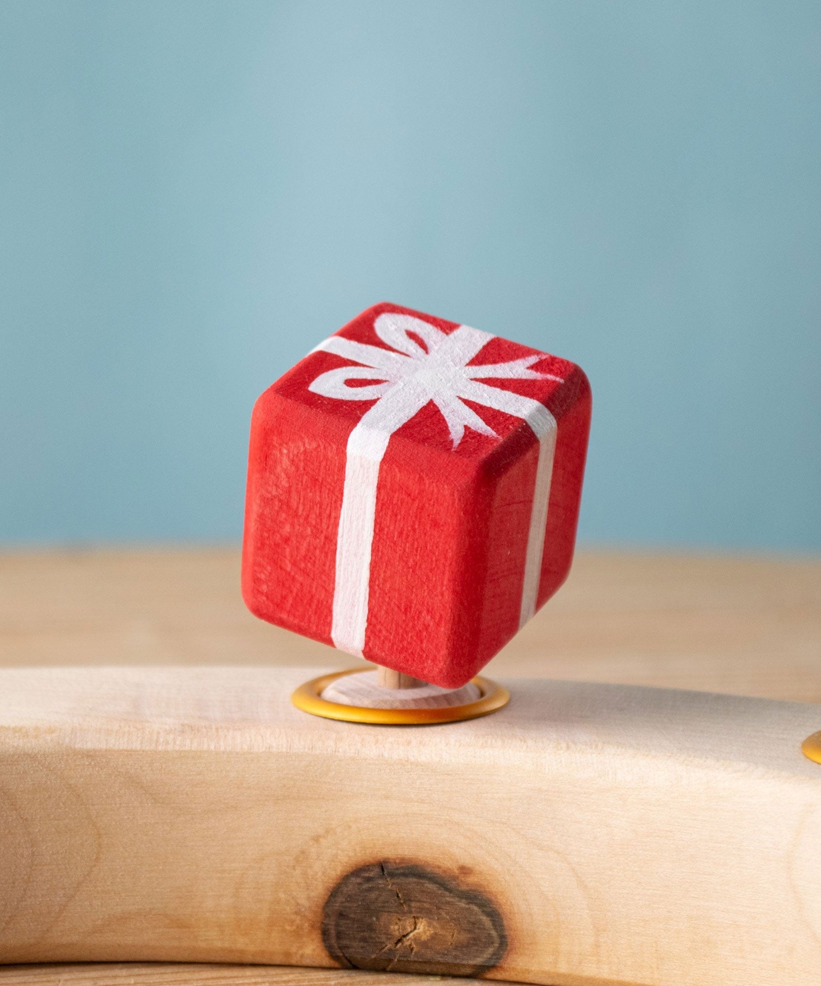 Bumbu red Festive Gift Celebration decorative Figure to fit on a Grimm's celebration ring shown on a celebration ring. These festive figures are perfect for your Chritmas celebration ring set up. Bumbu red Festive Gift Celebration decorative Figure to fit on a Grimm's celebration ring. These festive figures are perfect for your Christmas celebration ring set up. These expertly hand crafted items are part of a large range of wooden toys available here at Babipur. 